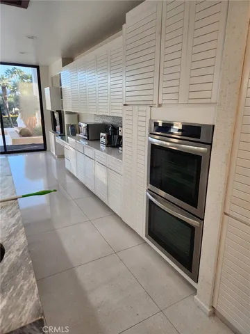 a kitchen with stainless steel appliances kitchen island granite countertop a stove a sink and a microwave