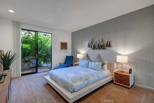 a bedroom with a bed a lamp and window