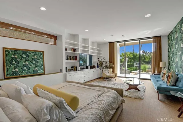 a bedroom with a large bed and a large window