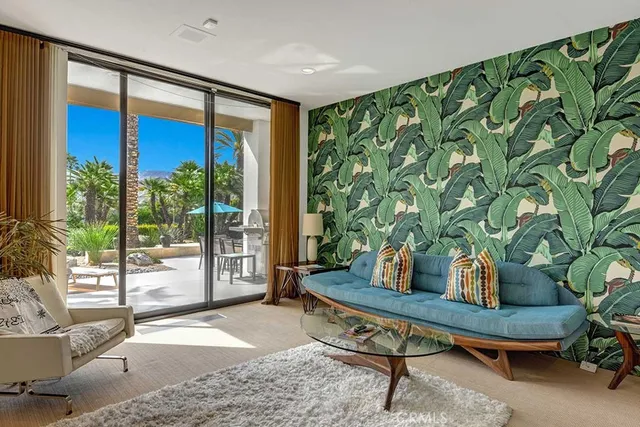 a living room with furniture and a potted plant