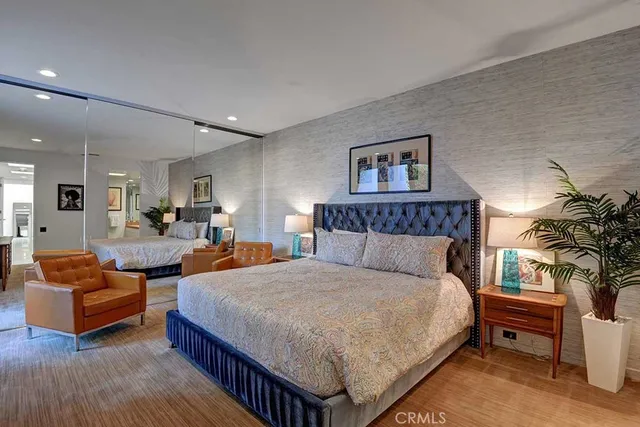 a spacious bedroom with a bed and a couch