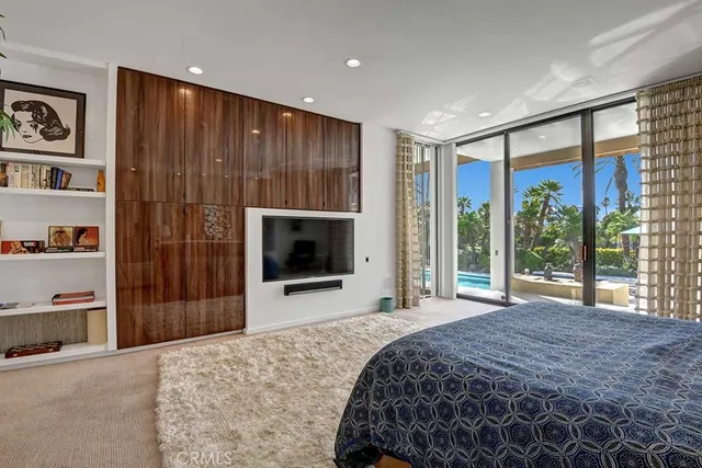 a bedroom with a bed and a flat screen tv