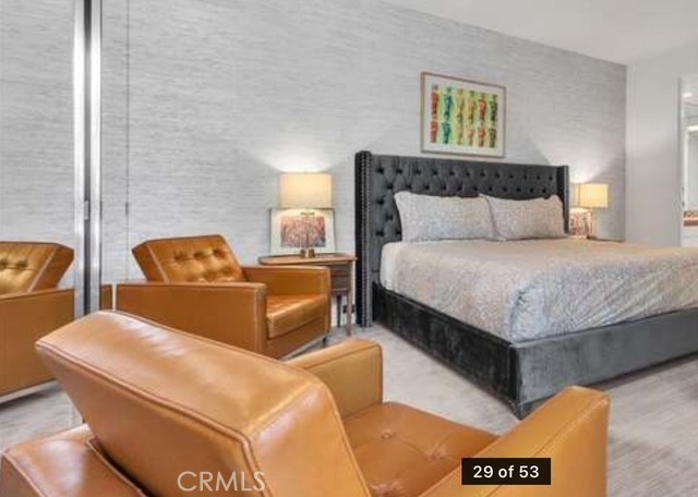 70955 Tamarisk Lane Rancho Mirage, CA 92270 - Photo 27 of 42 a bedroom with bed couch and painting on the wall