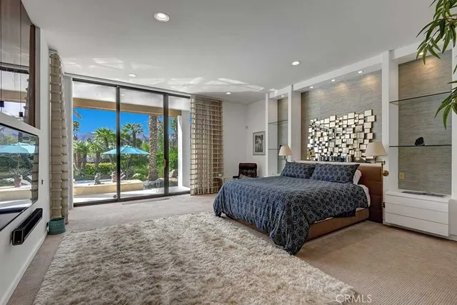 a spacious bedroom with a large bed and a large window