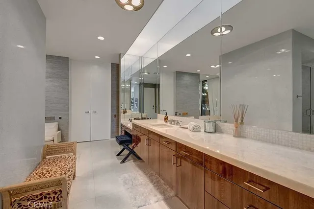 a bathroom with a double vanity sink mirror and shower