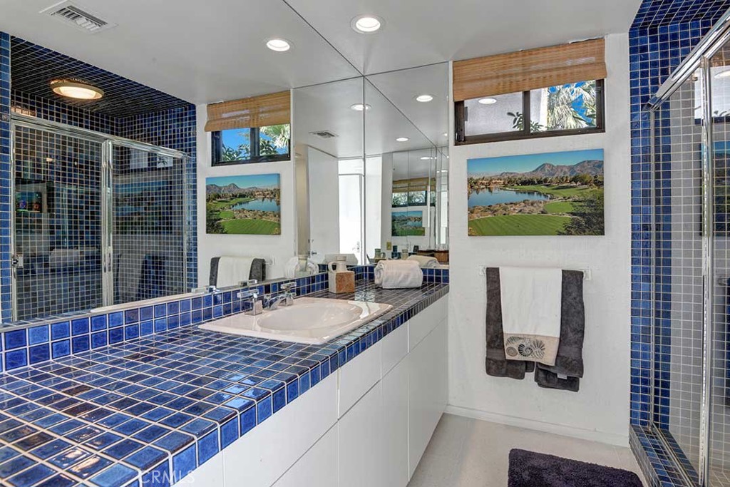 70955 Tamarisk Lane Rancho Mirage, CA 92270 - Photo 31 of 42 a bathroom with a granite countertop sink and a large mirror