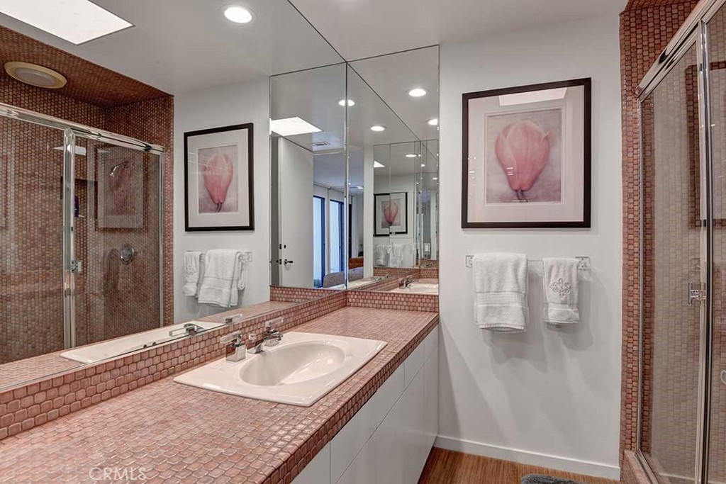70955 Tamarisk Lane Rancho Mirage, CA 92270 - Photo 35 of 42 a bathroom with a granite countertop sink a mirror and shower