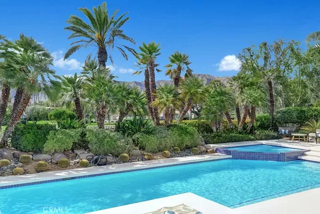 a view of house with swimming pool and porch