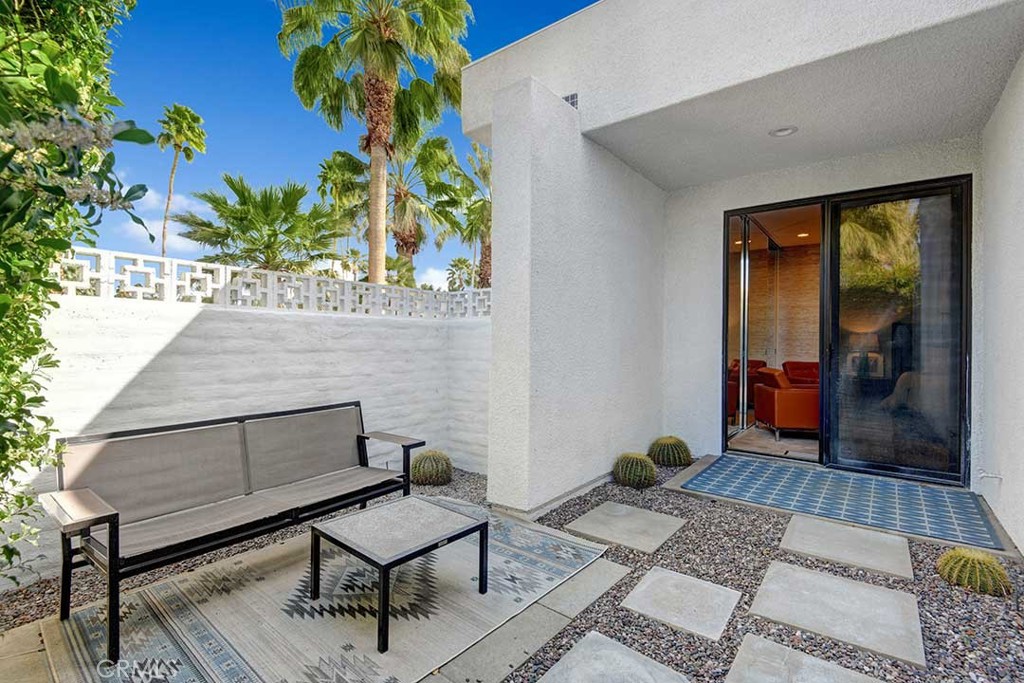 70955 Tamarisk Lane Rancho Mirage, CA 92270 - Photo 41 of 42 a living room with furniture and a potted plant