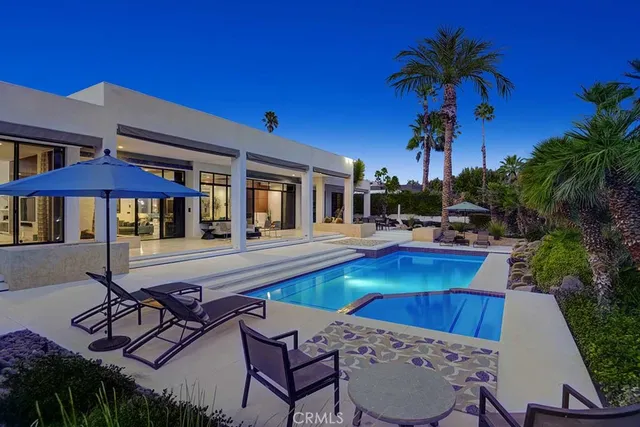a view of a patio with swimming pool table and chairs
