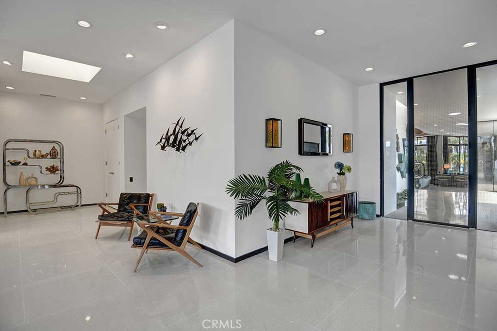 70955 Tamarisk Lane Rancho Mirage, CA 92270 - Photo 8 of 42 a living room with furniture and potted plants