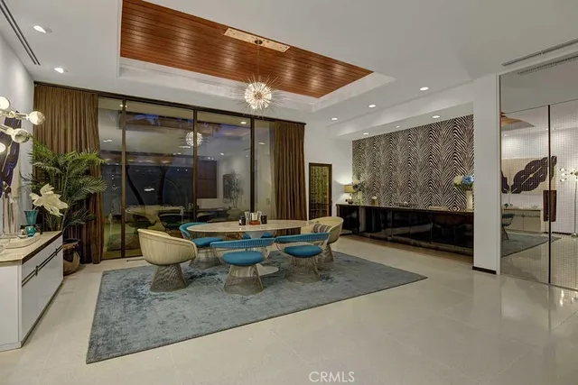 a dining room with furniture and a large window