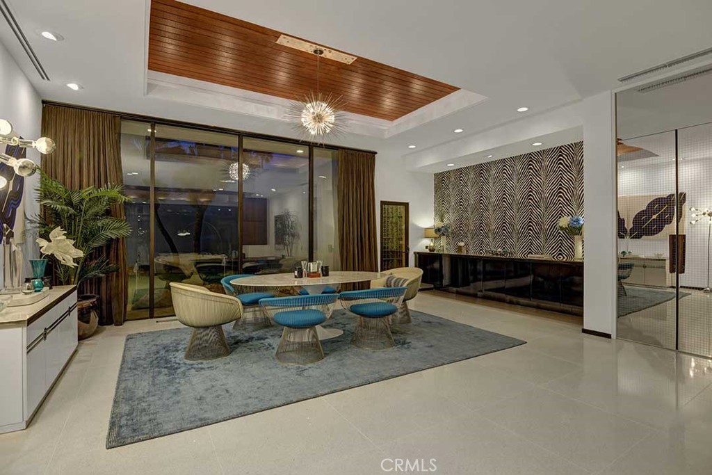 70955 Tamarisk Lane Rancho Mirage, CA 92270 - Photo 10 of 42 a dining room with furniture and a large window