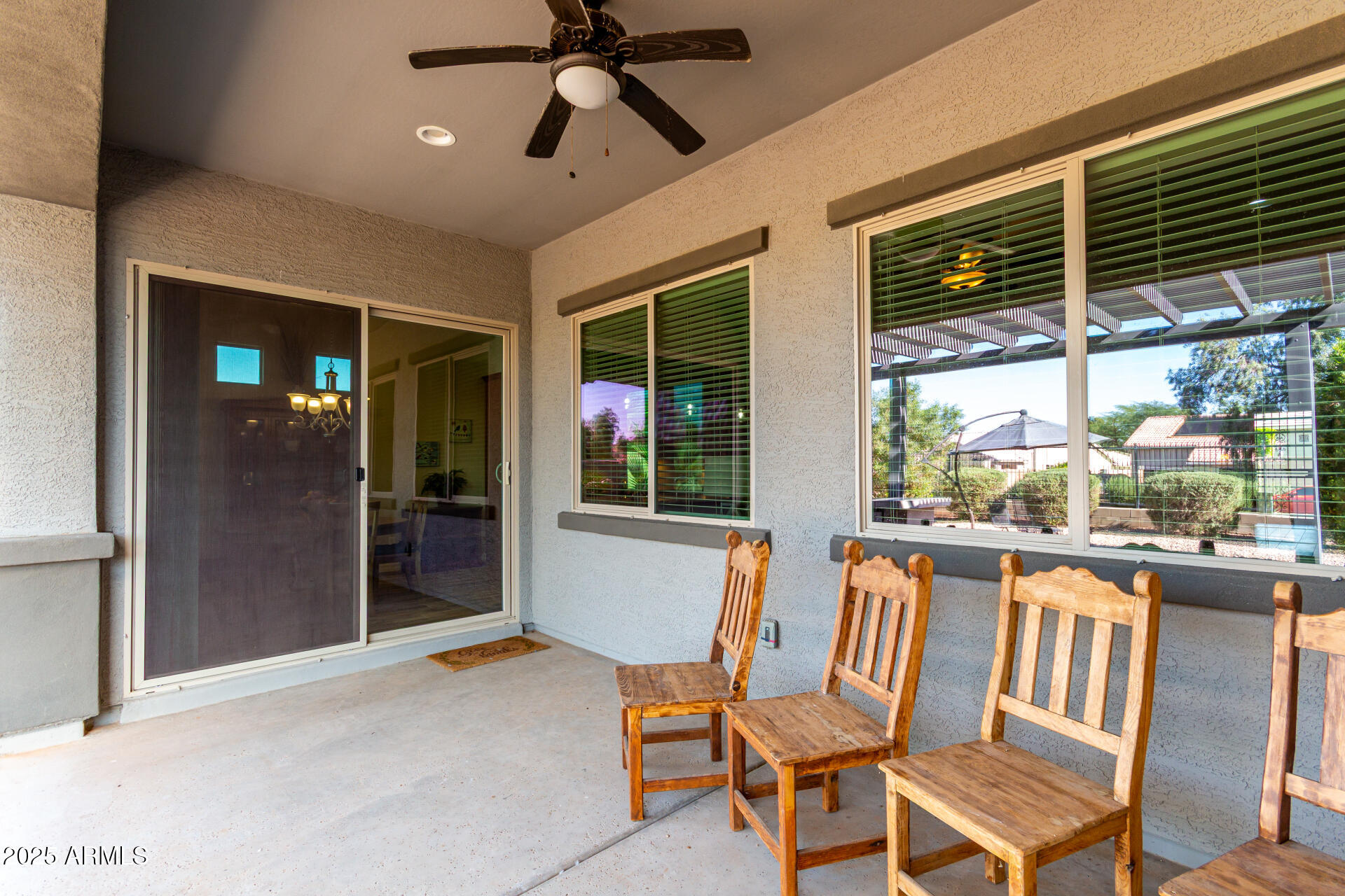 18190 North Stonegate Road Maricopa, AZ 85138 - Photo 18 of 27 a dining room with furniture large windows and a chandelier