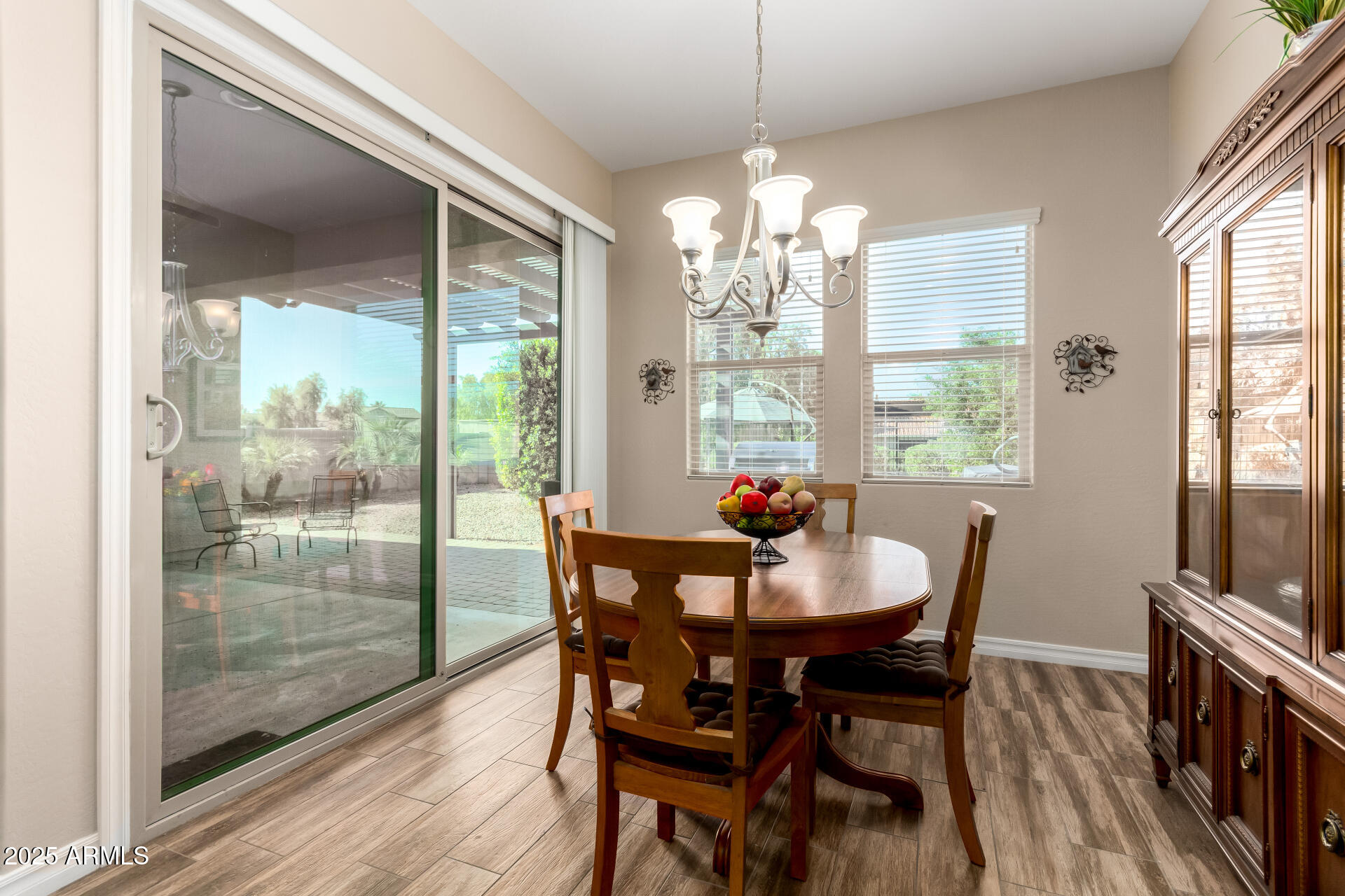 18190 North Stonegate Road Maricopa, AZ 85138 - Photo 26 of 27 a view of a dining room with furniture a chandelier and wooden floor