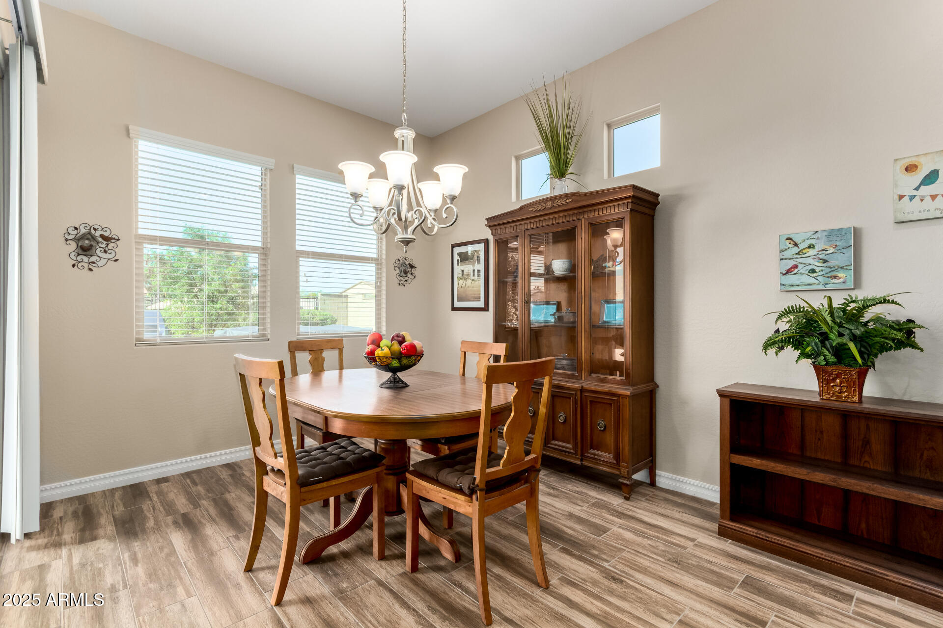 18190 North Stonegate Road Maricopa, AZ 85138 - Photo 4 of 27 a dining room with furniture a chandelier and wooden floor