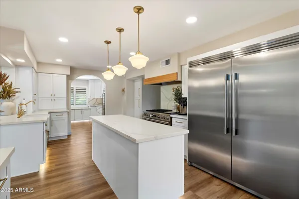 a kitchen with granite countertop white cabinets and white appliances
