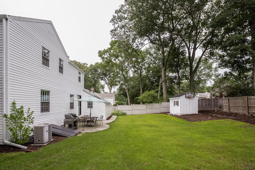 39 Intervale Road Darien, CT 06820 - Photo 15 of 18 a view of a white house with a yard and sitting area