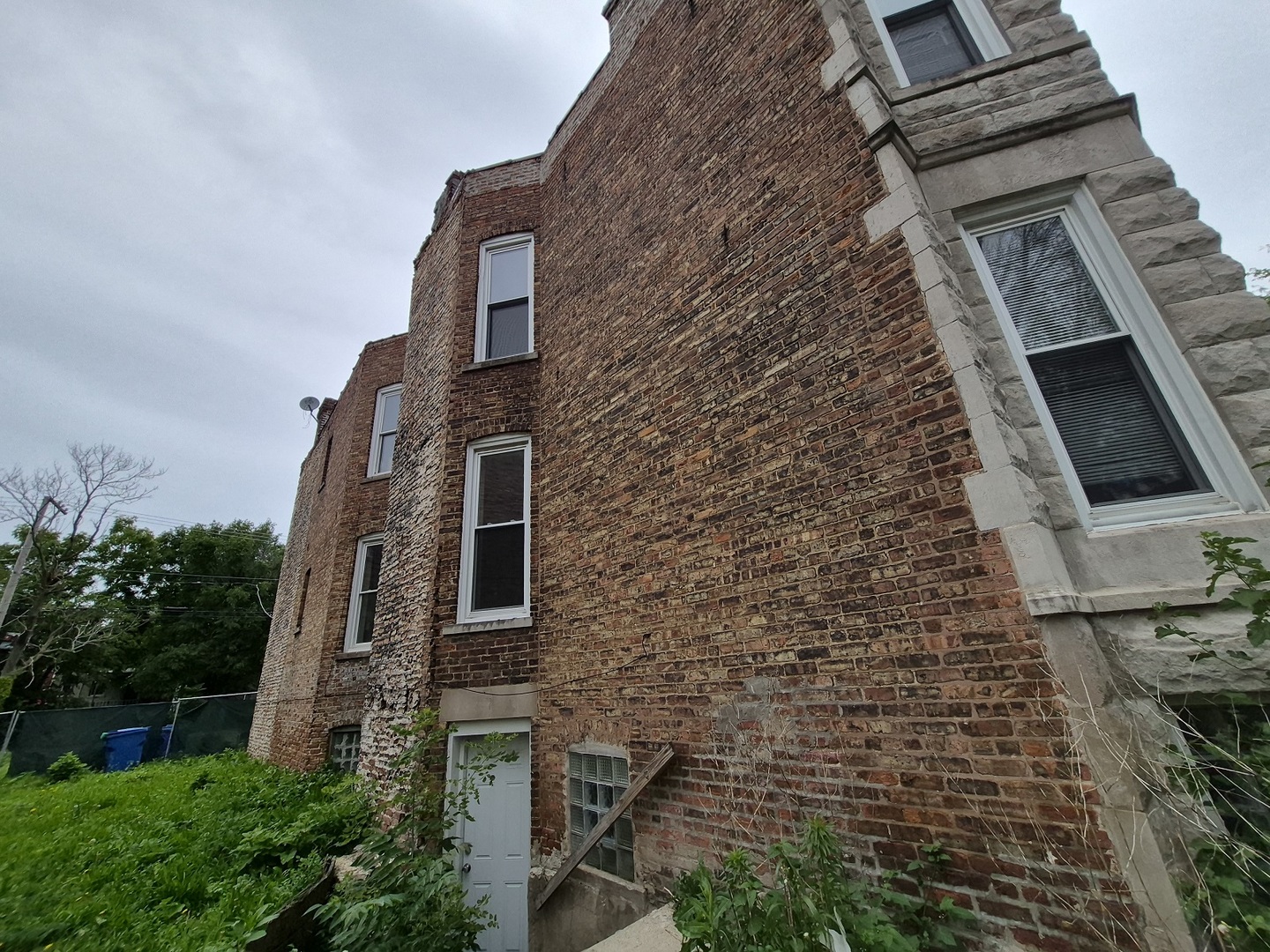4126 West Adams Street Chicago, IL 60624 - Photo 2 of 19 a brick building with a small yard