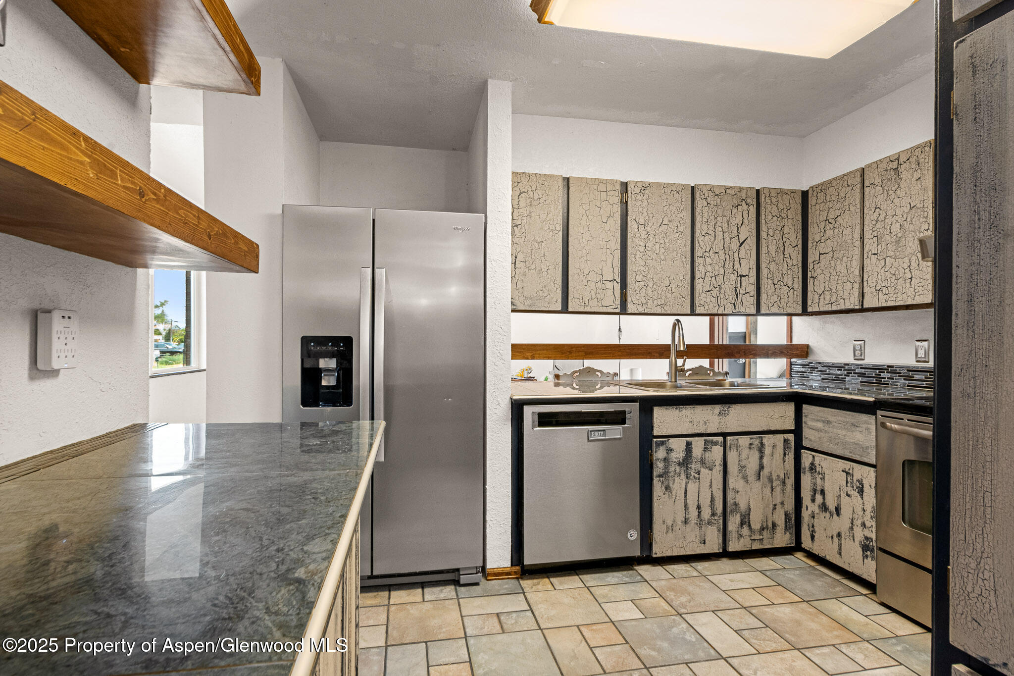 520 Aspen Avenue Rifle, CO 81650 - Photo 11 of 31 a kitchen with stainless steel appliances granite countertop a sink stove and refrigerator