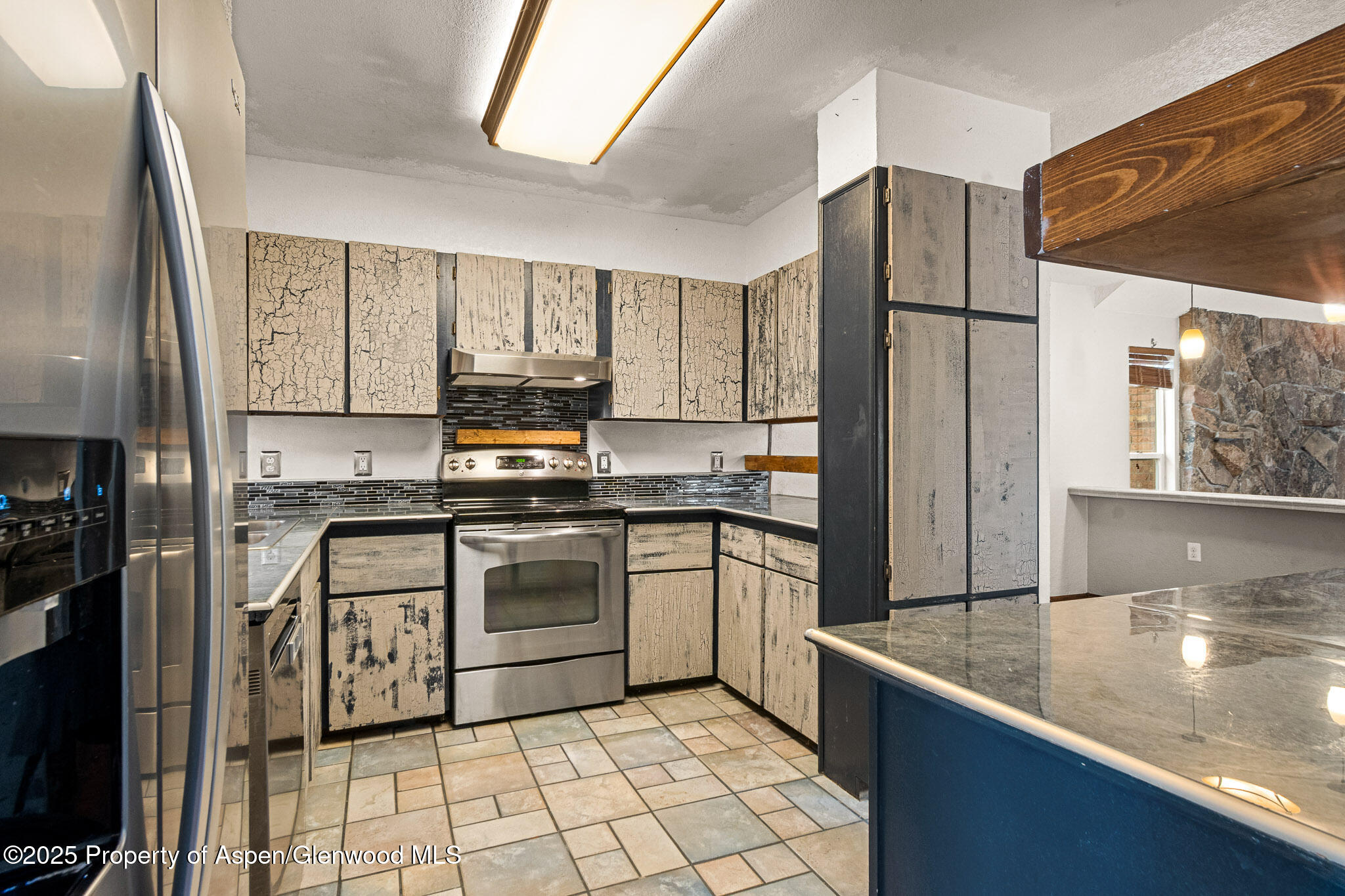 520 Aspen Avenue Rifle, CO 81650 - Photo 3 of 31 a kitchen with stainless steel appliances granite countertop a refrigerator a stove and a sink