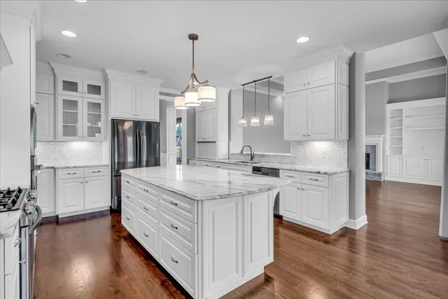 a bathroom with a granite countertop sink a toilet and a mirror