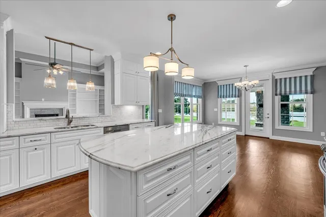 a bathroom with a granite countertop sink a toilet and a mirror
