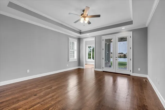 a kitchen with white cabinets and a window