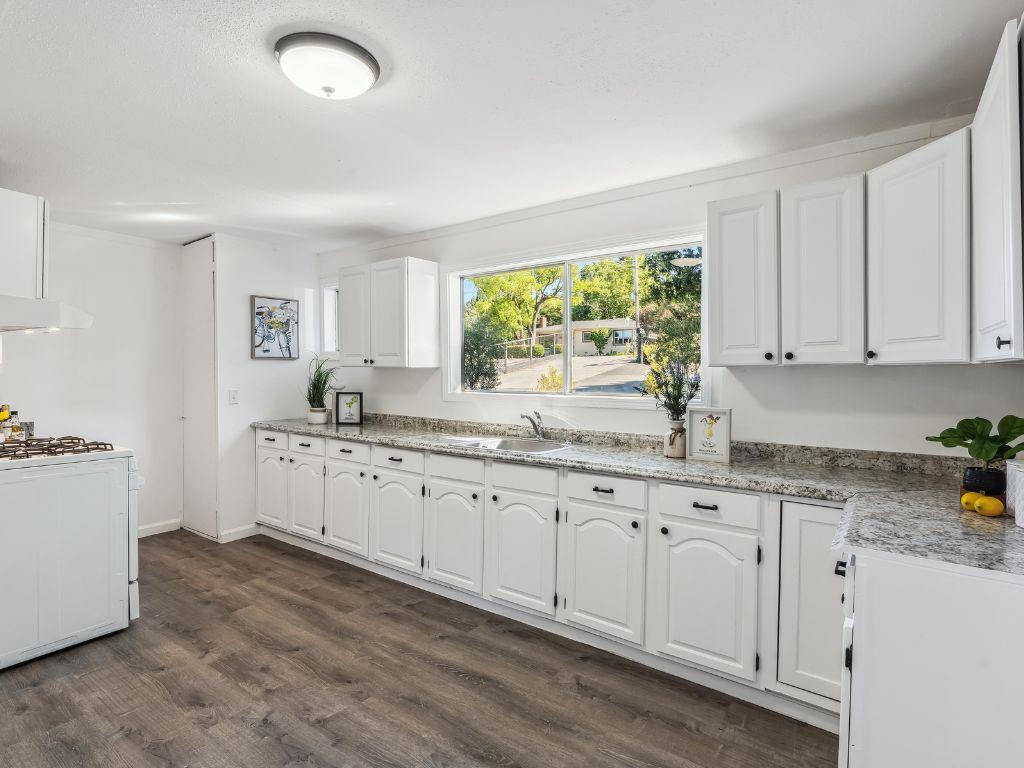 1684 Hill Road Novato, CA 94947 - Photo 11 of 21 a kitchen with granite countertop white cabinets white appliances a sink and a large window