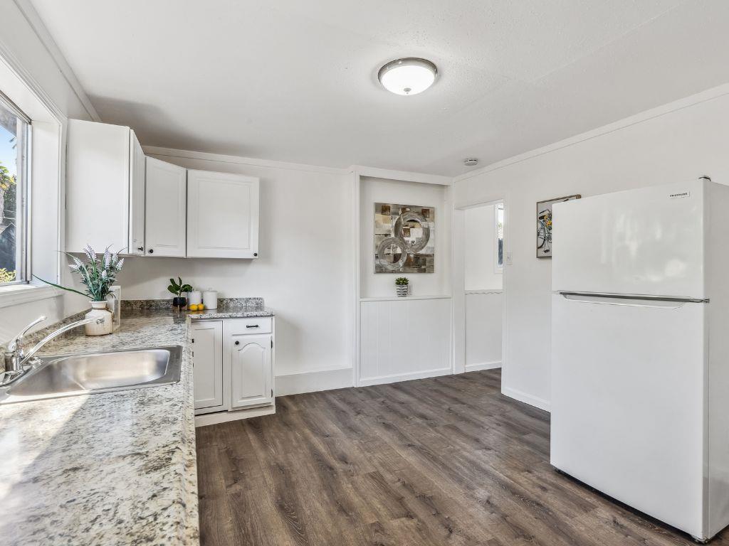 1684 Hill Road Novato, CA 94947 - Photo 12 of 21 a kitchen with granite countertop a refrigerator and a sink