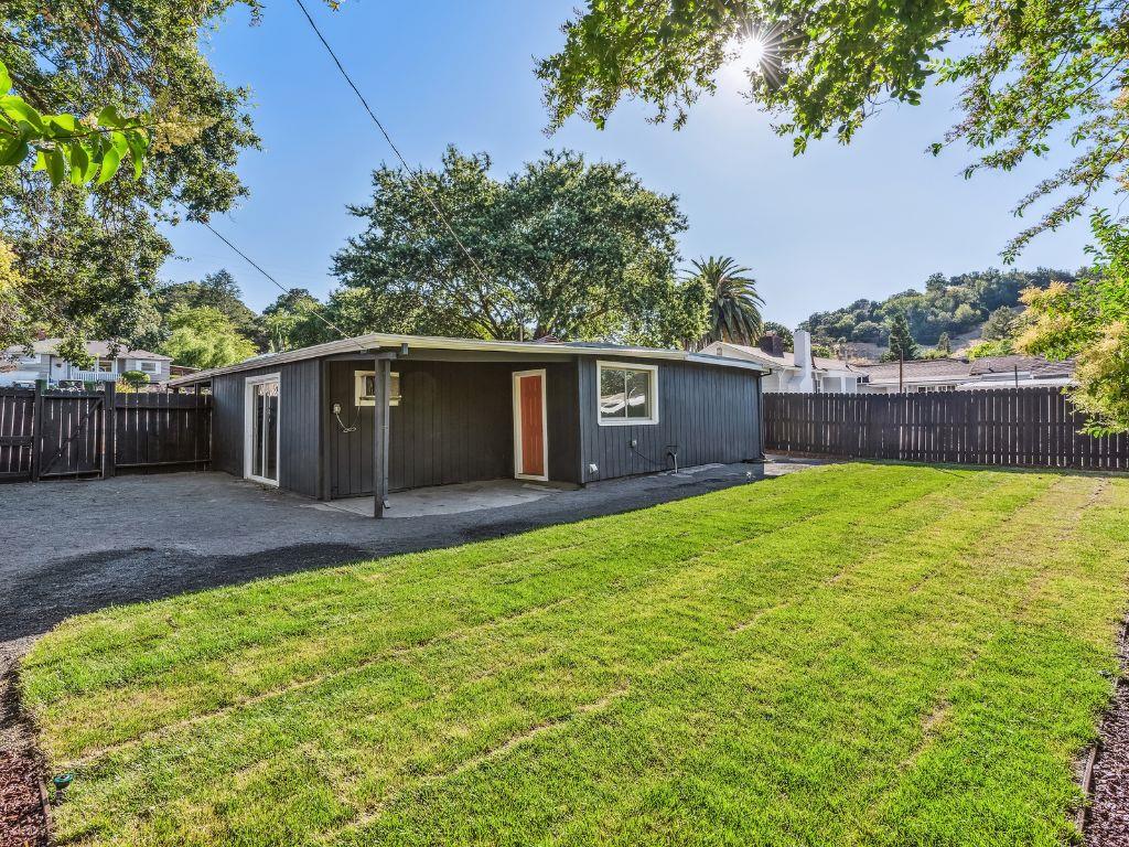 1684 Hill Road Novato, CA 94947 - Photo 20 of 21 a view of a house with a yard and a large tree