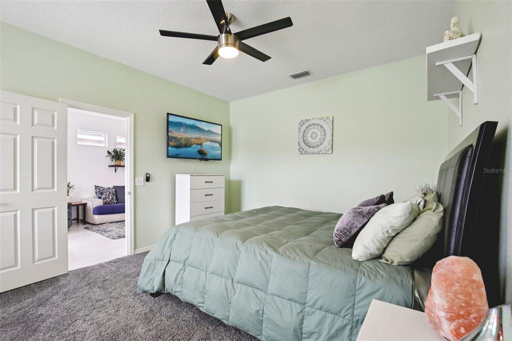 7164 Spikerush Court Lakewood Ranch, FL 34202 - Photo 18 of 36 a bedroom with a bed and a view of bedroom