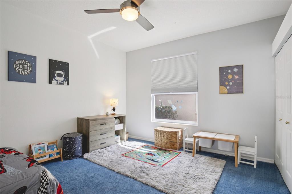 7164 Spikerush Court Lakewood Ranch, FL 34202 - Photo 23 of 36 a bedroom with a bed and a dresser in it