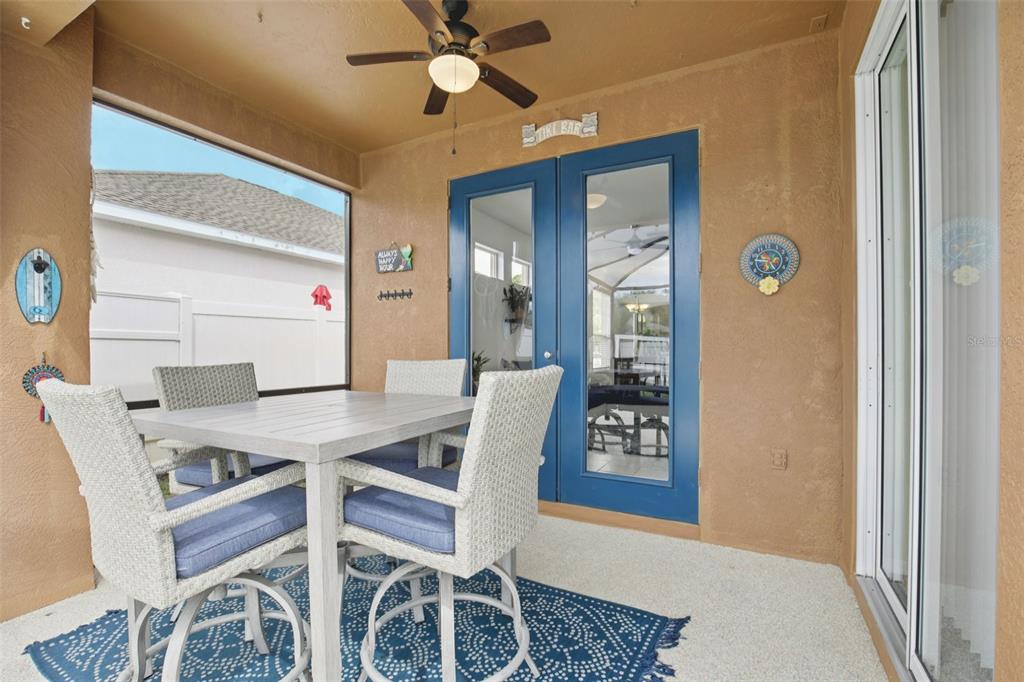 7164 Spikerush Court Lakewood Ranch, FL 34202 - Photo 26 of 36 a view of a dining room with furniture and a chandelier fan