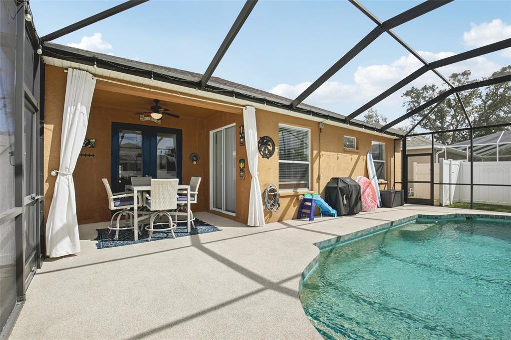 7164 Spikerush Court Lakewood Ranch, FL 34202 - Photo 27 of 36 a view of a porch with chairs and backyard