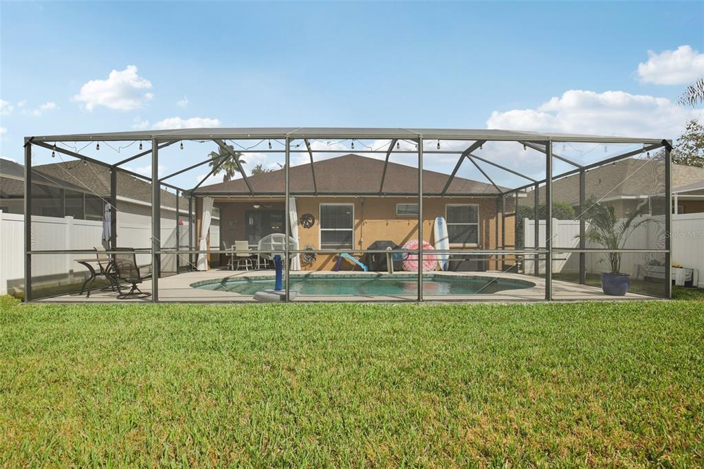 7164 Spikerush Court Lakewood Ranch, FL 34202 - Photo 29 of 36 a view of a house with a backyard porch and sitting area