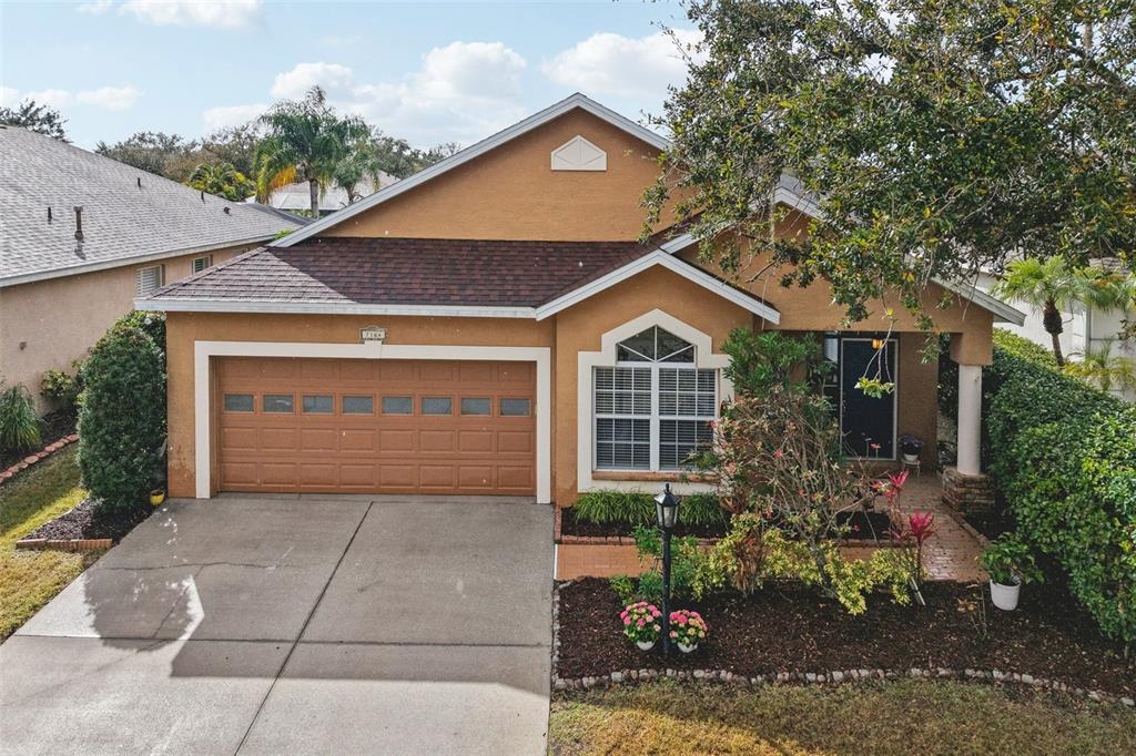 7164 Spikerush Court Lakewood Ranch, FL 34202 - Photo 31 of 36 a view of a house with a yard and potted plants