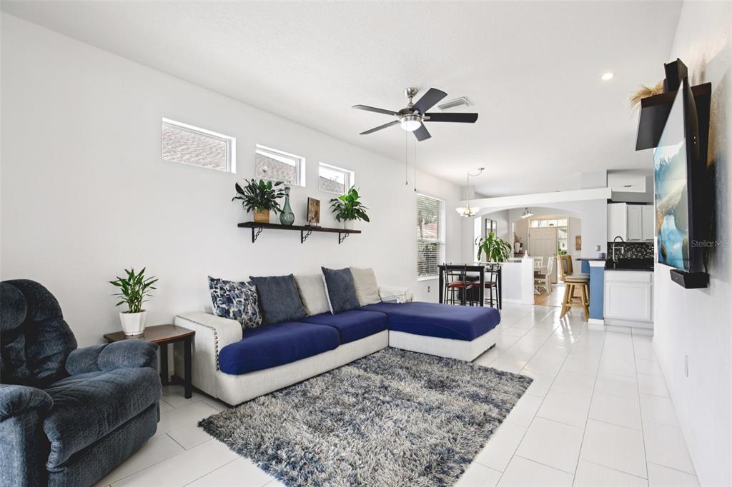 7164 Spikerush Court Lakewood Ranch, FL 34202 - Photo 8 of 36 a living room with furniture and wooden floor