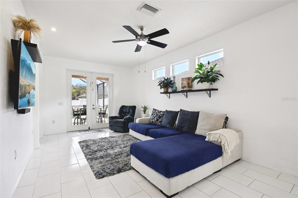 7164 Spikerush Court Lakewood Ranch, FL 34202 - Photo 9 of 36 a living room with furniture and a wooden floor
