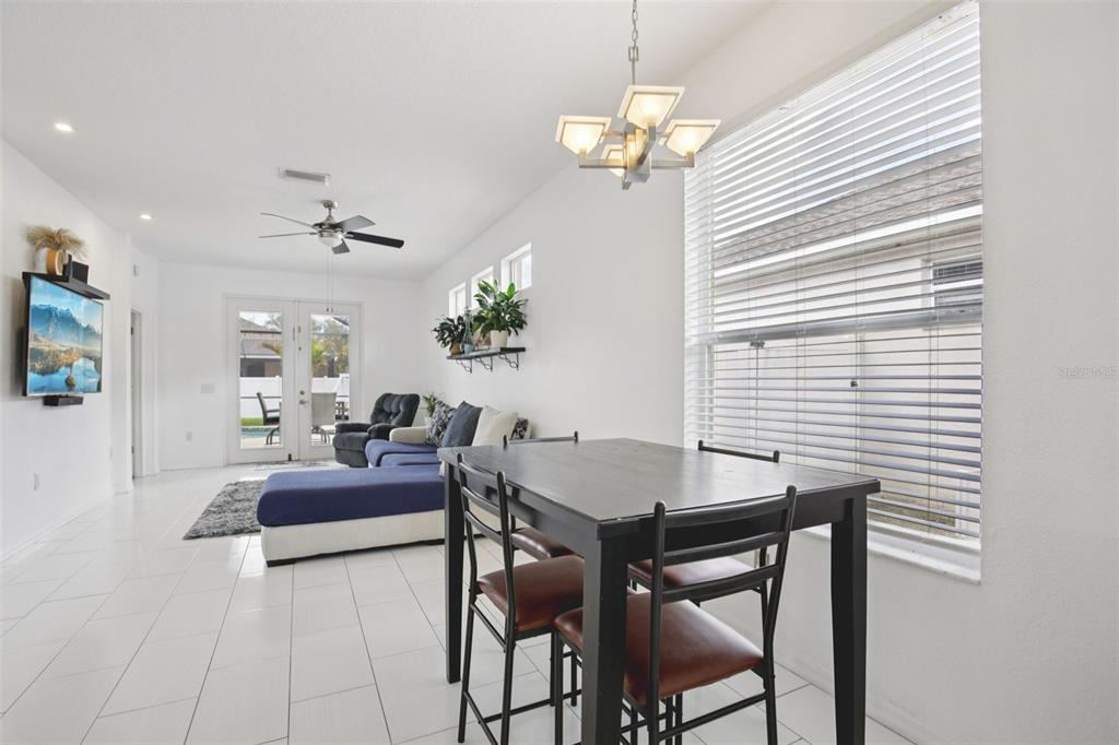 7164 Spikerush Court Lakewood Ranch, FL 34202 - Photo 10 of 36 a view of a dining room with furniture and chandelier