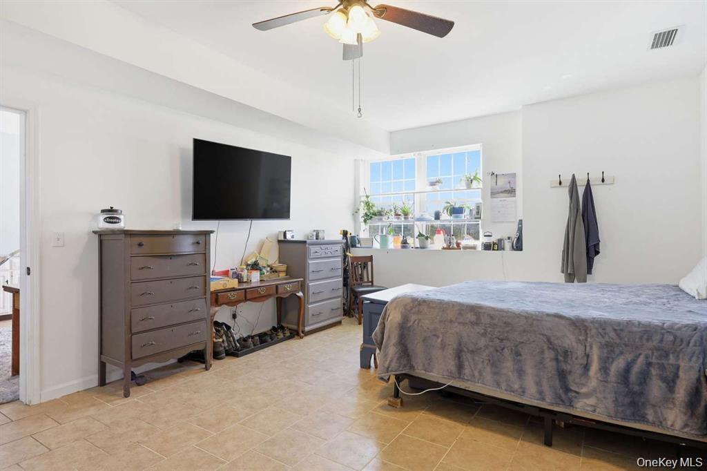 133 Old Chester Road Goshen, NY 10924 - Photo 24 of 33 a bedroom with a bed and a flat screen tv