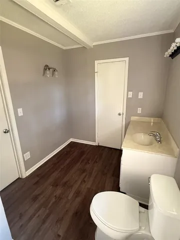 a white toilet sitting next to a bathroom sink