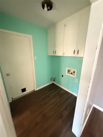 a view of a room with wooden floor and cabinet