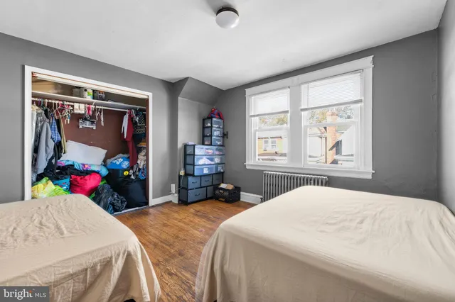 a bedroom with bed and a large window