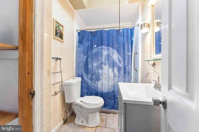 a white toilet sitting next to a bathroom sink