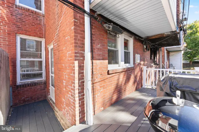 a view of a patio with table and chairs and wooden floor
