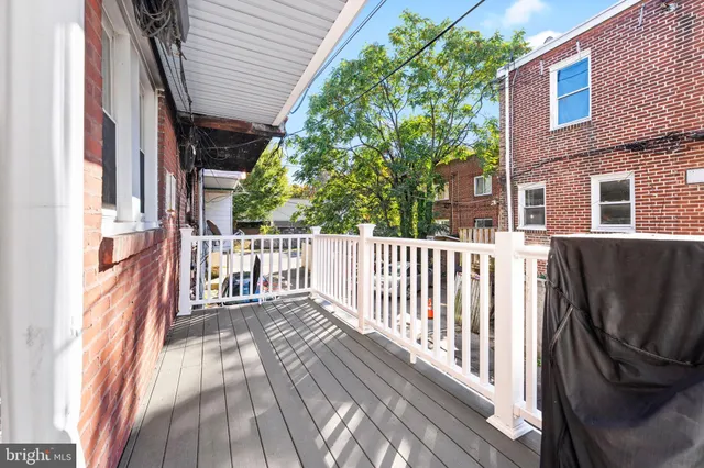 a view of a house with a small deck