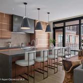 a kitchen with stainless steel appliances granite countertop a stove top oven a dining table and chairs with wooden floor