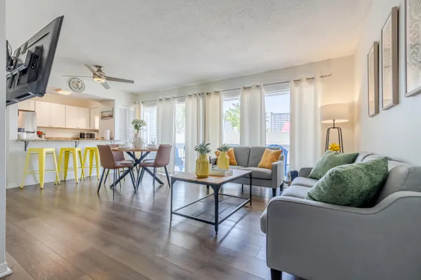 a living room with furniture and wooden floor