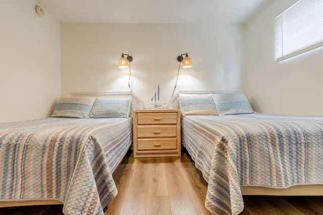 a bedroom with a bed and a night stand